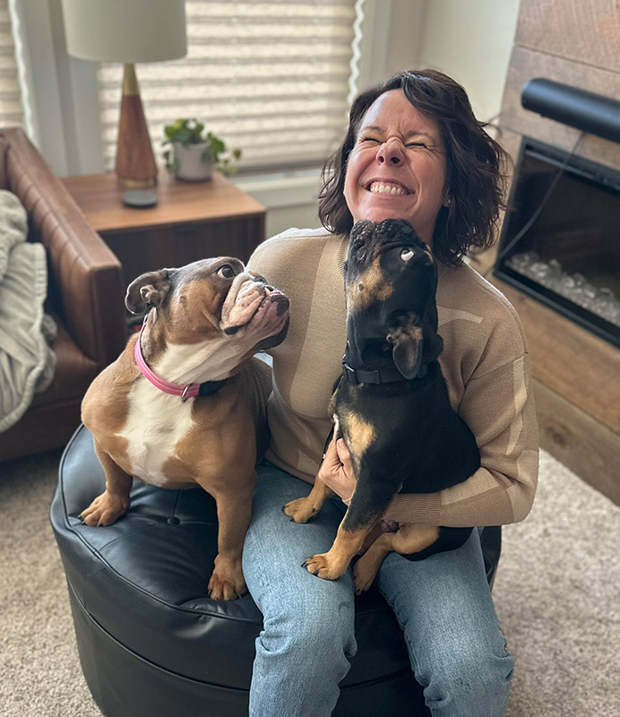 Kate Rome receiving some love from Penelope, her 4-year-old English Bulldog, and Bruce Wayne, her 5-month-old French Bulldog. (Source: Kate Rome)