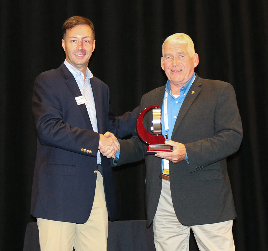 AFIA’s Paul Davis (left) congratulates Wes Klett on becoming AFIA’s 2023 Member of the Year.