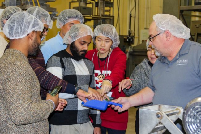 Course participants getting hands-on pet food extrusion training