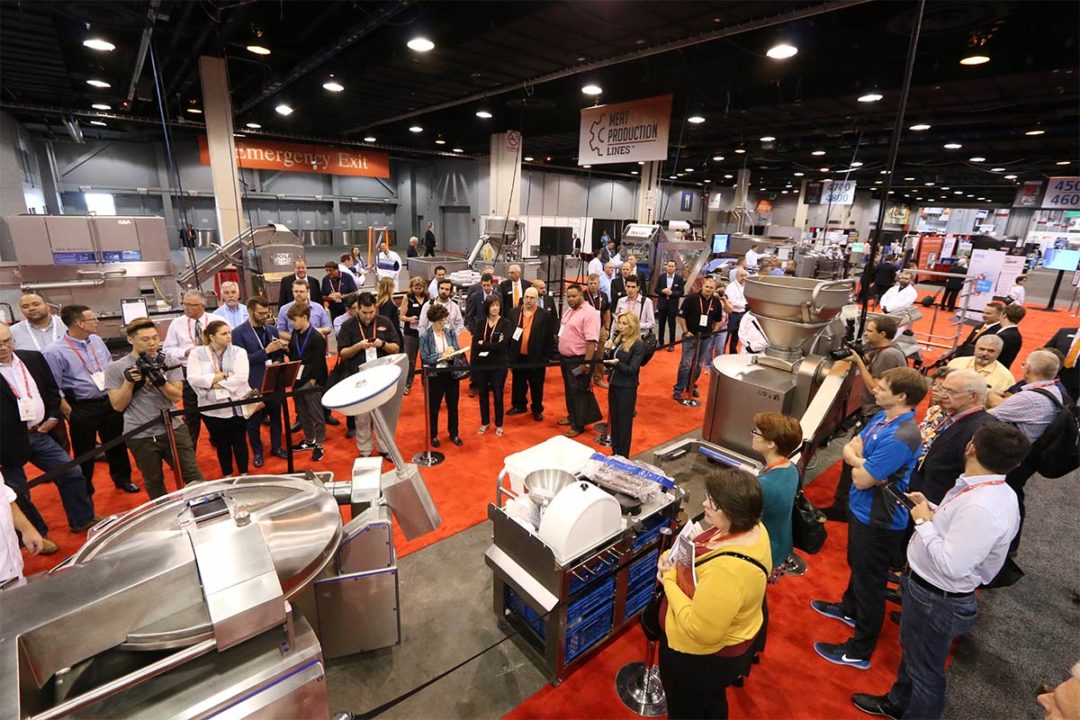 Crowd gathered around production line exhibit at PROCESS EXPO