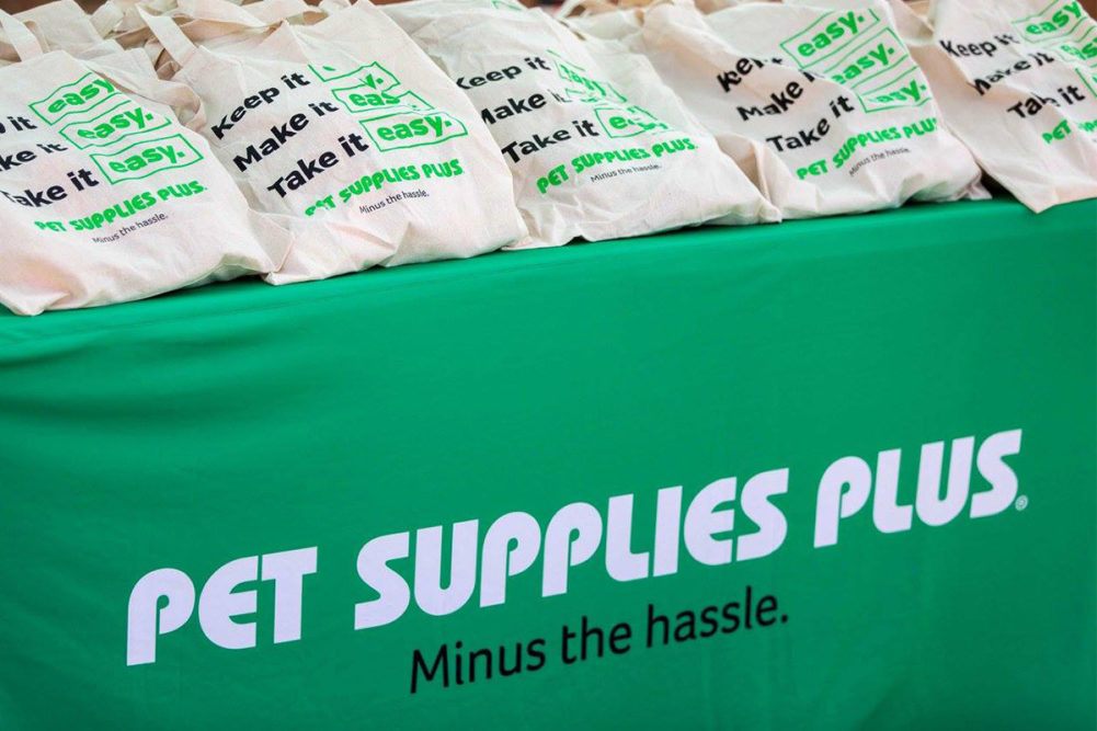 Pet Supplies Plus logo on green tablecloth