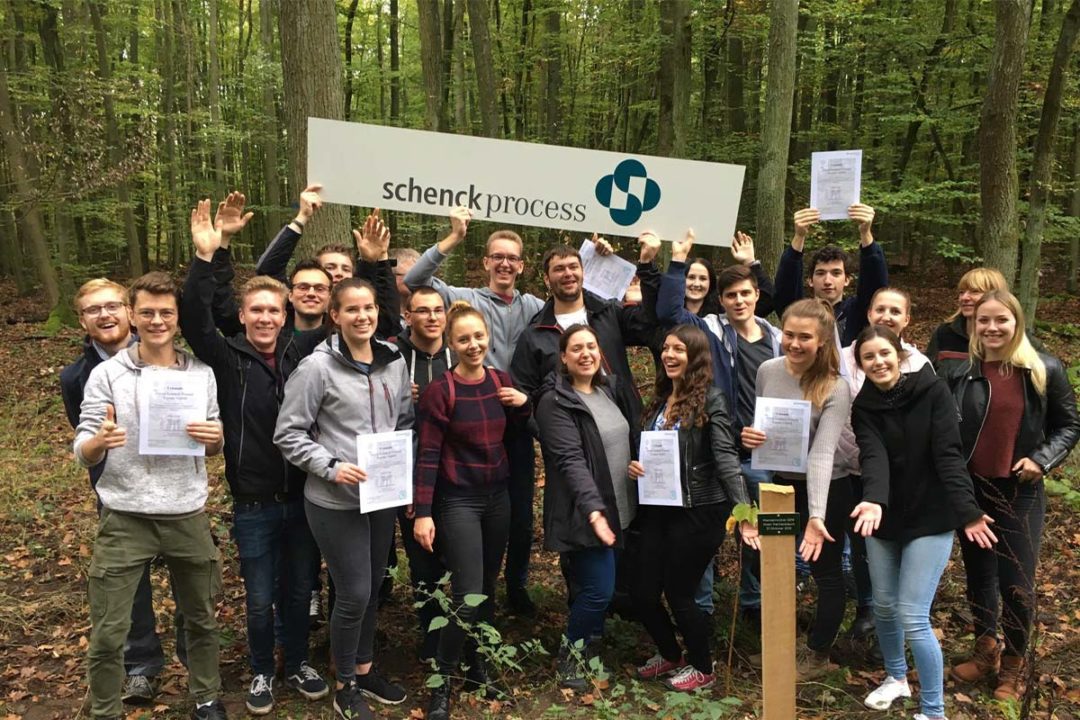 Trainees plant trees as part of Schenck Process's environmental efforts