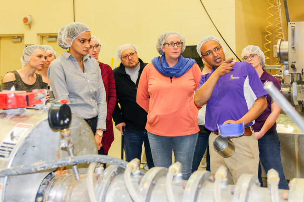 Participants from the IGP-KSU Pet Food Formulation for Commercial Production course visiting the O.H. Kruse Feed Mill with Sajid Alavi, professor within Kansas State’s Grain Science and Industry, to discuss the extrusion process.