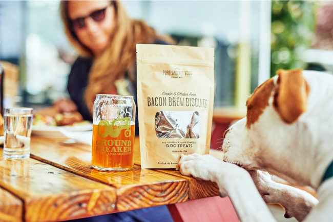 Portland Pet Food Bacon Brew Biscuits on table next to beer
